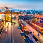 Cargo ship in the harbor at sunset .