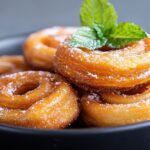 Golden jalebi syrup spirals sweet sticky indulg mint powdered sugar