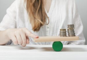 woman-holding-her-finger-balance-with-coins.jpg
