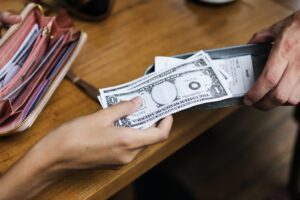 Woman paying cash for bill restaurant