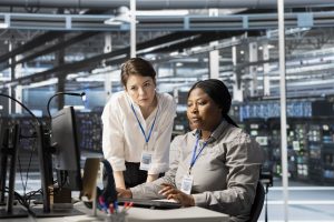 Team of admins working together in server hub, analyzing rigs data